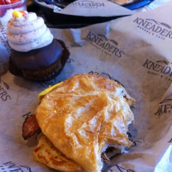 Kneaders Bakery & Cafe - Large croissant breakfast sandwich and super yummy spice cupcake. - Cafes Near Me - Parker, Colorado Kneaders Bakery & Cafe - Large croissant breakfast sandwich and super yummy spice cupcake. - Cafes Near Me - Parker, Colorado