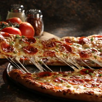 Toarmina's Pizza - a slice being taken out of a pizza - Pizza Near Me - Romulus, Michigan Toarmina's Pizza - a slice being taken out of a pizza - Pizza Near Me - Romulus, Michigan