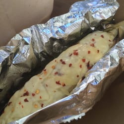 9th Ave Street Food - Street Corn: Grilled whole corn on a husk covered in mayo, parmesan cheese, crushed red pepper flakes and salt & pepper.