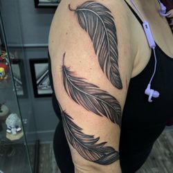 Trust Tattoo - Three feathers along my right arm.