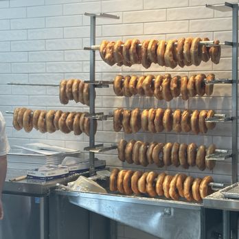 Peachey's Baking - Doughnuts hanging after being glazed - Food Trucks Near Me - Sarasota, Florida