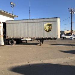 UPS Customer Service Center - Trucks bringing and taking packages
