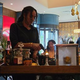 Server lighting the device to smoke the drink.