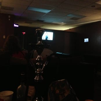 The Shisha Lounge - people watching television in the dark - Hookah Bars Near Me - Killeen, Texas The Shisha Lounge - people watching television in the dark - Hookah Bars Near Me - Killeen, Texas