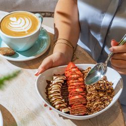 Pura Vida Miami - Handcrafted coffee with latte art and a hazelnut crunch acai bowl, served in a warm and welcoming all day café atmosphere.