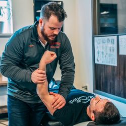 Columbus Pain & Performance - Dr. Kelly manual muscle testing an injured shoulder. Proper assessment directs our care.