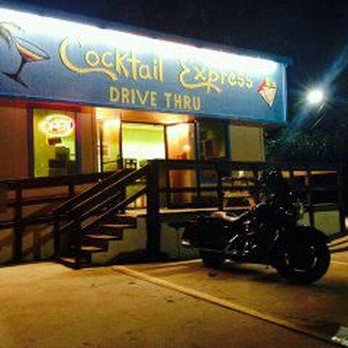 Cocktail Express - a motorcycle parked in front of a restaurant - Cocktail Bars Near Me - Conroe, Texas