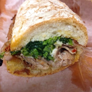 Stocked Cafe - The inside of a Capicola Style Roast Pork, melt provolone, d'espelette pepper, broccoli rabe sandwich - New American Near Me - Brooklyn, New York