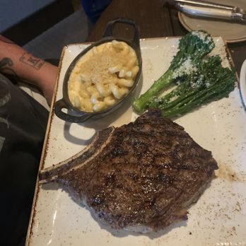 J Gilbert's - Cowboy cut ribeye with broccolini and lobster Mac - Bars Near Me - Omaha, Nebraska J Gilbert's - Cowboy cut ribeye with broccolini and lobster Mac - Bars Near Me - Omaha, Nebraska