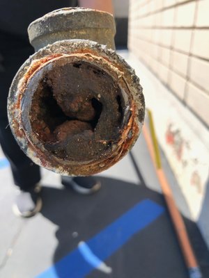 Corrosion in Galvanized Pipes - Galvanized pipes react with minerals in the water, producing calcium deposits. The calcium built in the lines restricts the tube's diameter and causes lower water pressure throughout your home. Also, it causes the tap water to have rusty color. As corrosion didn't build up evenly in all pipes, the client was experiencing low water pressure in some of the faucets and taps. As a result, we removed all galvanized pipes and repiped the entire house with copper pipes.