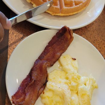 Another Broken Egg Cafe - A Belgian waffle with a side of eggs and bacon. Disappointed at the plate dressing. It did not look welcoming nor appetizing. - Breakfast & Brunch Near Me - Dunwoody, Georgia