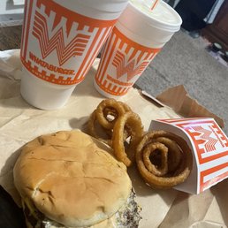 a hamburger and onion rings a hamburger and onion rings