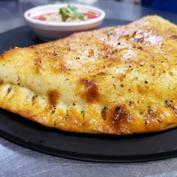 Pizza Amore - a close up of a piece of pizza on a plate - Pizza Near Me - Carencro, Louisiana