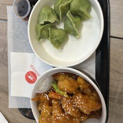 Emperor Dumpling - Veggie dumplings on the right, Orange Chicken with Rice and veggies on the left