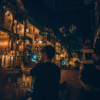 Pow Pow - a man standing at a bar - Bars Near Me - Montreal, Quebec Pow Pow - a man standing at a bar - Bars Near Me - Montreal, Quebec