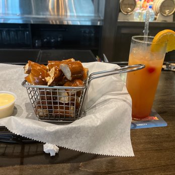 The Brass Tap - Pretzel bites with queso and the drink of the week (Malibu sunset) - American Near Me - Williamsburg, Virginia