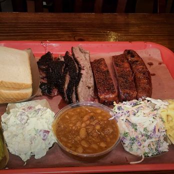 Terry Black's Barbecue - Pickles,potato salad, beans ,Cole slaw, Mac and cheeses,white bread brisket, ribs ,and sausage - Barbeque Near Me - Austin, Texas