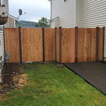 RK Fencing & Construction - a wooden fence in a backyard - General Contractors Near Me