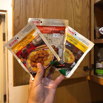 Nikka Japanese Market - a hand holding three packets of food - International Grocery Near Me - Goleta, California