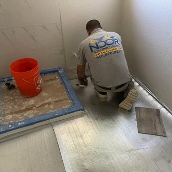 Noor Construction - Worker setting new shower stall and toilet area. As well as prepping floor for flooring. - General Contractors Near Me Noor Construction - Worker setting new shower stall and toilet area. As well as prepping floor for flooring. - General Contractors Near Me