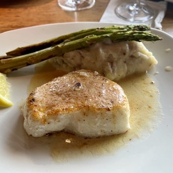 Landry's Seafood House - Chilean sea bass "pan seared" swimming in a pool of lemon butter, with mashed potatoes and "fresh" asparagus. - Seafood Near Me - Branson, Missouri Landry's Seafood House - Chilean sea bass "pan seared" swimming in a pool of lemon butter, with mashed potatoes and "fresh" asparagus. - Seafood Near Me - Branson, Missouri