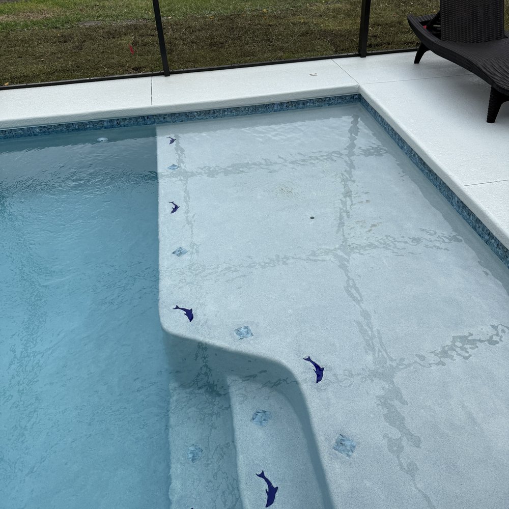 Pools By Warren Construction - Sun deck with insets of Dolphins and Diamonds. - Pool & Hot Tub Service Near Me - Lecanto, Florida Pools By Warren Construction - Sun deck with insets of Dolphins and Diamonds. - Pool & Hot Tub Service Near Me - Lecanto, Florida