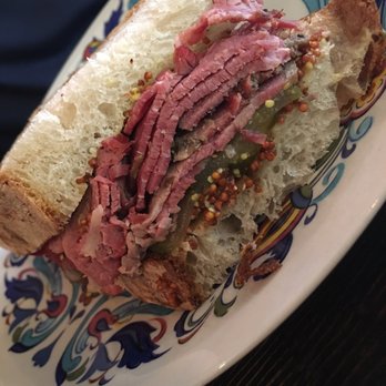 Chartier - Smoke meat sammie - too much condiments. Crunchy sour bites takes taste of smoked meat away. Flavours not balanced - French Near Me - Beaumont, Alberta