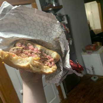Wendy's - a person holding a sandwich in a wrapper - Burgers Near Me - North Windham, Connecticut