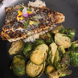 WALLEYE FILLET pepita and guajillo coated, lemon caper buerre blanc sauce with brussels and vegetable rice.