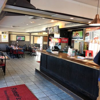 Foster's Grille - a man standing in a restaurant - Burgers Near Me - Warrenton, Virginia