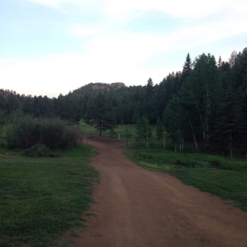Lost Burro Campground - Dirt road heading over the creek to the tent area. Our tent was set up about 100 yards to the right tucked up next to the trees. - Campgrounds Near Me - Cripple Creek, Colorado Lost Burro Campground - Dirt road heading over the creek to the tent area. Our tent was set up about 100 yards to the right tucked up next to the trees. - Campgrounds Near Me - Cripple Creek, Colorado