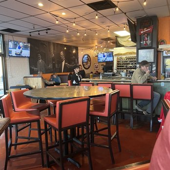 BZ's Bistro - a man sitting at a table - Pizza Near Me - Tucson, Arizona BZ's Bistro - a man sitting at a table - Pizza Near Me - Tucson, Arizona