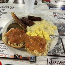 Julia's Restaurant - Tomato gravy on a biscuit with grits, eggs sausage and bacon it was really good, reminds me of Sunday meals at my Grandparents home