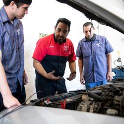 UEI College - Chula Vista - Automotive Technician instructor demonstrating to students.