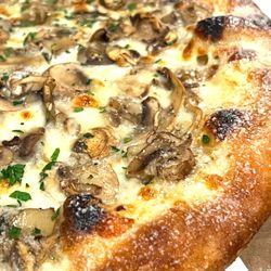 Pizzeria Maki - The Fun Guy:  Garlic Confit base, mozzarella and swiss topped with house roasted mushrooms.