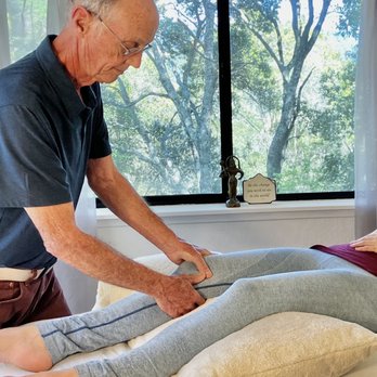 Tom Pettengill Massage Therapy - Assessing the client's knee pain - from excess running. - Massage Near Me - Aptos, California Tom Pettengill Massage Therapy - Assessing the client's knee pain - from excess running. - Massage Near Me - Aptos, California