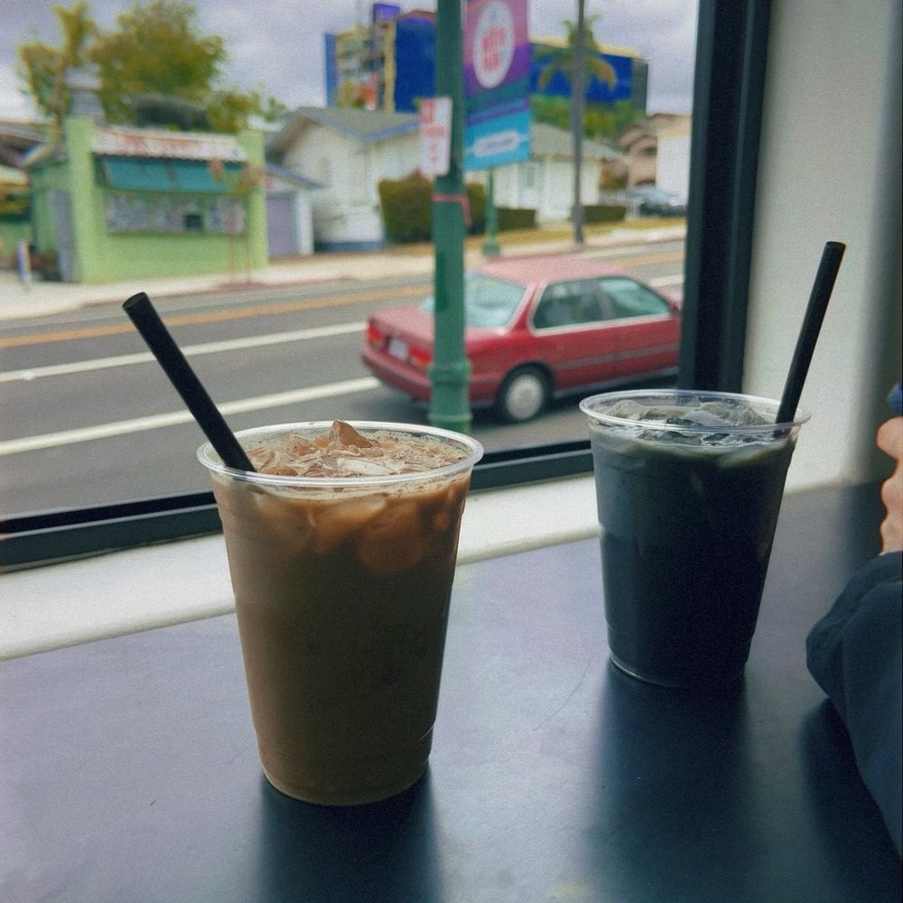 Genteel Coffee - L: Iced Foxtrot, syrup with orange extract, cinnamon, and cardamom.  R: Iced Vixen, activated charcoal latte that's sweetened with agave. - Coffee & Tea Near Me - San Diego, California