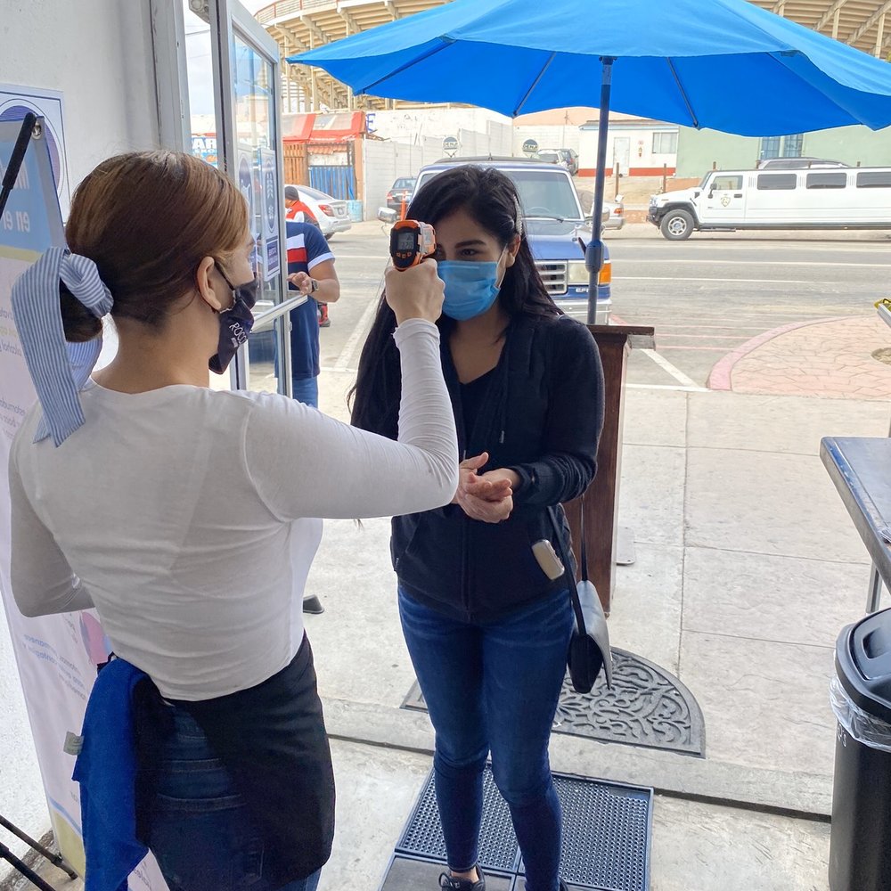 Checking the temperature before coming in during 2020 quarantine Checking the temperature before coming in during 2020 quarantine