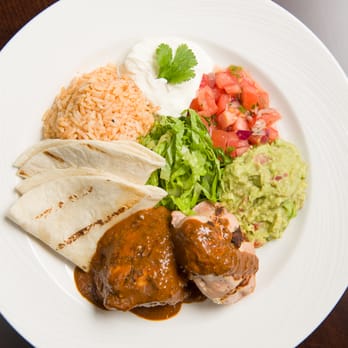 Eatery101 at St. Clair College - Boneless braised chicken, Spanish rice, toasted chili-chocolate sauce, guacamole, pico de gallo, sour cream, flour tortillas. - Canadian (New) Near Me - Windsor, Ontario Eatery101 at St. Clair College - Boneless braised chicken, Spanish rice, toasted chili-chocolate sauce, guacamole, pico de gallo, sour cream, flour tortillas. - Canadian (New) Near Me - Windsor, Ontario