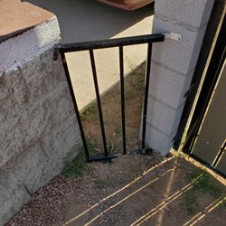 Hula Constrution - The back fence did not line up with the front yard fence so the owner put this small metal gate, two different colors and screws are showing