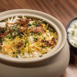 Kebab & Kurry - Murgh Dum Biryani, chicken and basmati rice slow-cooked in a clay pot, with raita.