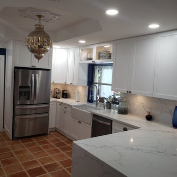 Miami Kitchens & More - a kitchen with white cabinets and marble countertops - General Contractors Near Me - Miami, Florida