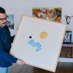 The Preservation Framer - Matt holding a stretched and frame canvas painting by Sean Spellman
