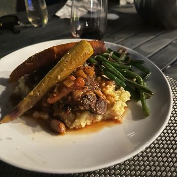 Chef Palm Springs - Short Ribs over mashed potatoes with a Piri-Piri sauce green beans with Cremi mushrooms topped with sautéd root vegetables. - Personal Chefs Near Me Chef Palm Springs - Short Ribs over mashed potatoes with a Piri-Piri sauce green beans with Cremi mushrooms topped with sautéd root vegetables. - Personal Chefs Near Me
