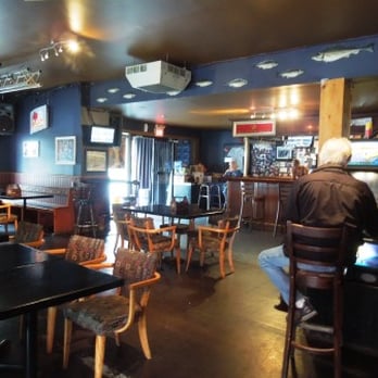 Kellys Pub - a man sitting at a bar - Pubs Near Me - St John's, Newfoundland and Labrador