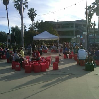 Moveable Feast - a large group of people sitting on red barrels - Food Trucks Near Me - Santa Clara, California
