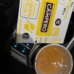 a box of campero next to a cup of coffee a box of campero next to a cup of coffee