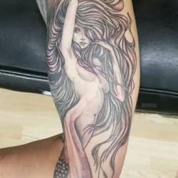 Skin Deep Tattoo & Piercings - The tail wraps around her arm.