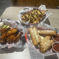 The Dirty Armadillo - From the top: chili fries, homemade mozzarella sticks, bourbon wings