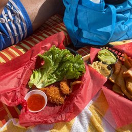 a person sitting on a towel with food a person sitting on a towel with food
